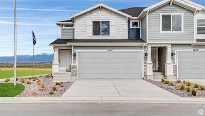 View of front of home featuring a mountain view and a garage | Image 1