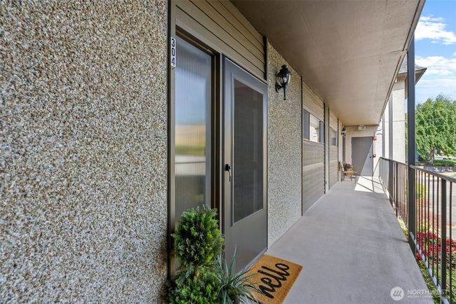 From the covered parking to the entry, you will stay dry on those rainy winter days. | Image 7