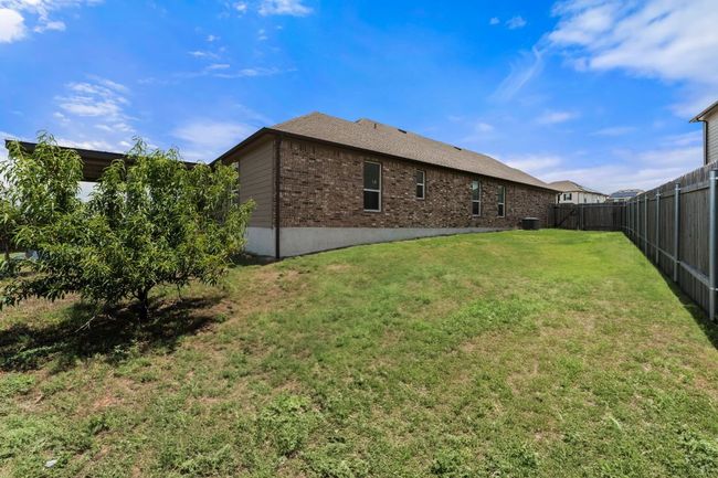 Back of property with a fenced backyard, brick siding, and roof with shingles | Image 34