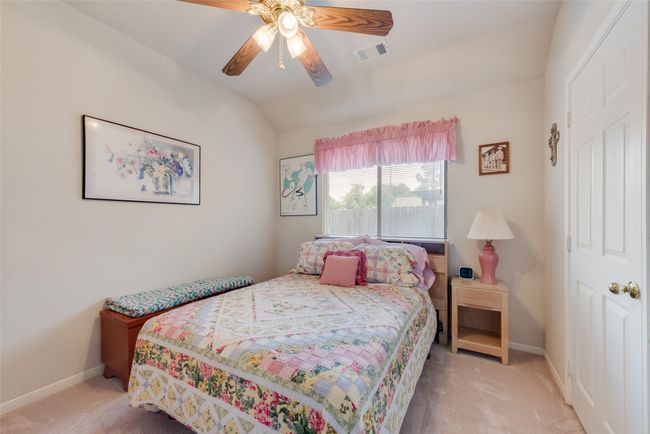 Bedroom with carpet floors, vaulted ceiling, baseboards, and a ceiling fan | Image 26
