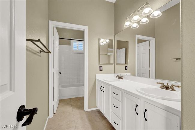 Bathroom featuring double vanity, tile patterned flooring, and shower / bath combination | Image 32
