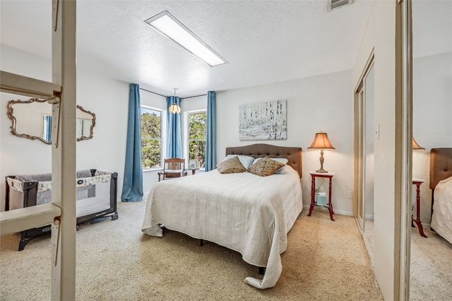 The adjacent spacious 2nd bedroom, with 2 standard closets, and collapsable ladder leading to a "surprise" loft! | Image 32