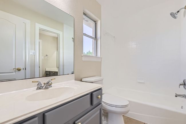 Full bathroom with toilet, bathtub / shower combination, and vanity | Image 34