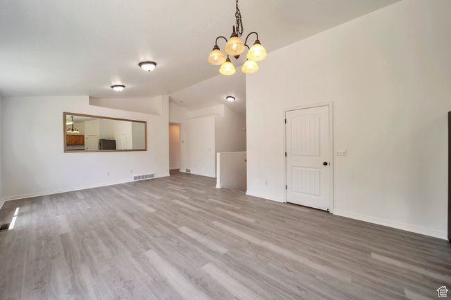 LVP, a chandelier, lofted ceiling | Image 7