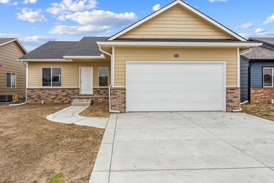 View of front of home with a garage and central AC unit | Image 2