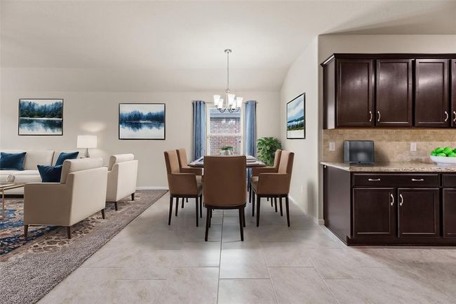 In this open concept design, the kitchen serves as the heart of the home, where meals are prepared, conversations flow, and memories are made. With the dining area nearby, it's easy for family members to enjoy casual meals together or for guests to chat with the cook while meals are being prepared. | Image 8