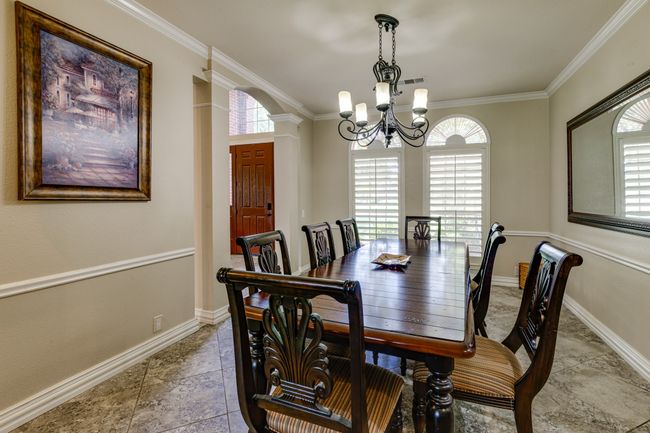 Dining room with a chandelier, plenty of natural light, and ornamental molding | Image 19