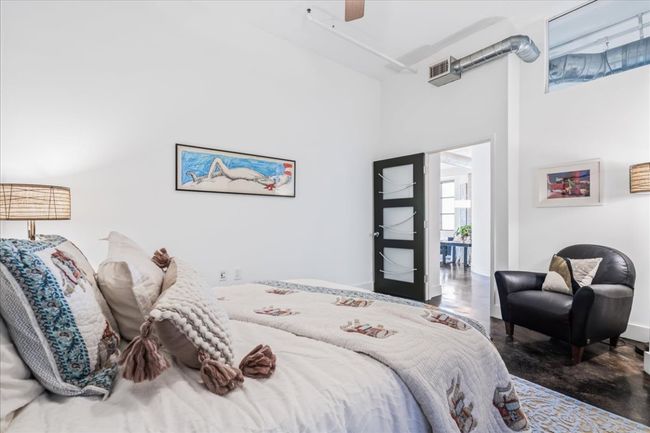 Bedroom featuring a high ceiling and ceiling fan | Image 22