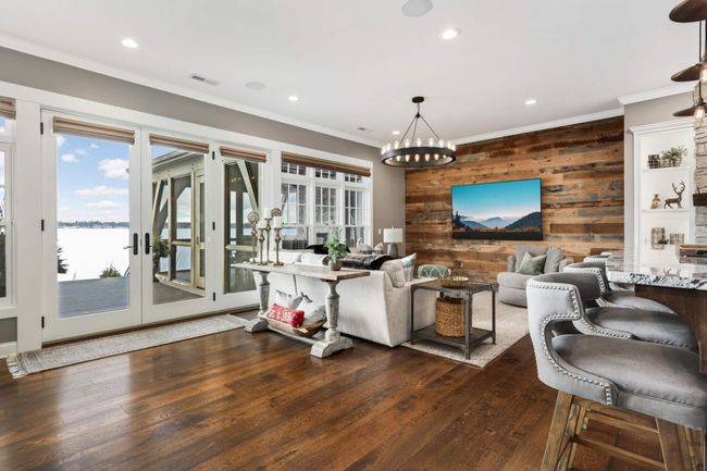 Another view of the family room, the lake view and 3 season porch | Image 19