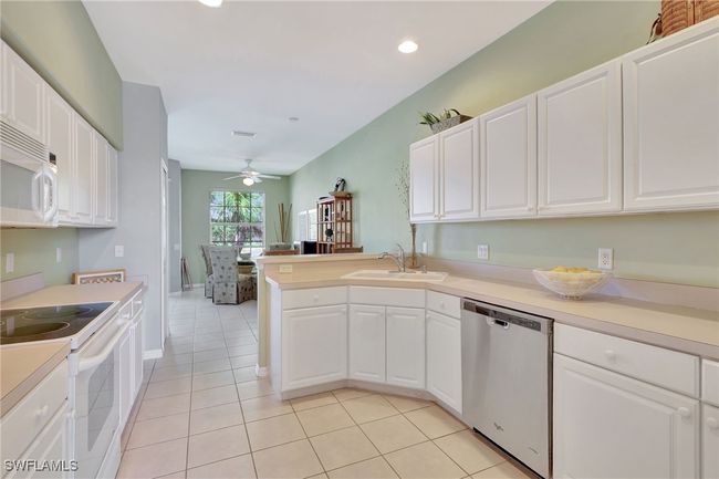 Kitchen that flows to both the dinette and the dining room, lots of cabinet space and pantry | Image 20