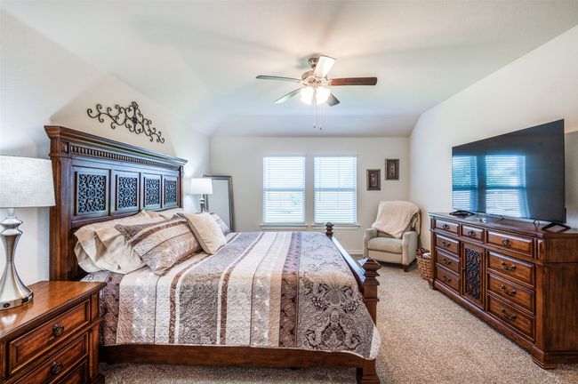 Bedroom with light carpet, vaulted ceiling, and a ceiling fan | Image 21