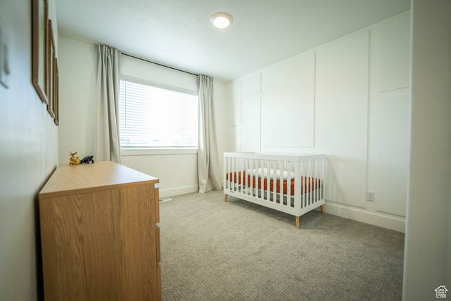 Bedroom #3 features a crisp white-trimmed accent wall and soft, neutral tones. This spacious bedroom is perfect for a nursery, kids’ room, or welcoming guests. Light, bright, and full of possibilities! | Image 24