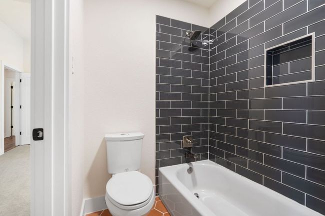 Thoughtfully placed between secondary bedrooms, both guest bathrooms offer functionality and privacy for a variety of living arrangements. | Image 25