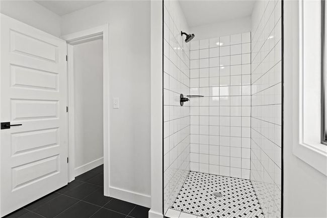 Full bath featuring a stall shower and tile patterned flooring | Image 31