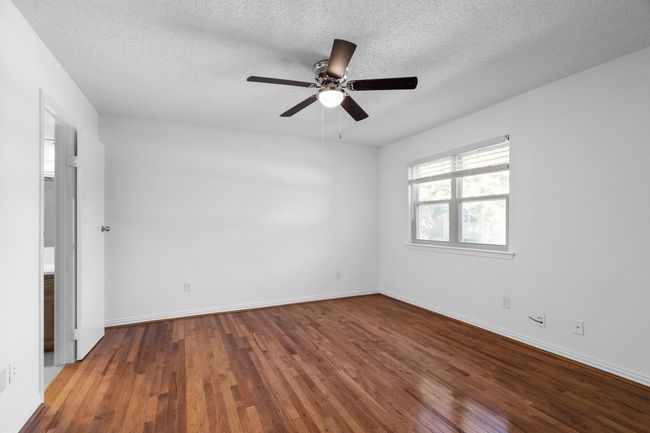 Second bedroom with ceiling fan, hardwood / wood-style floors, and a textured ceiling | Image 22