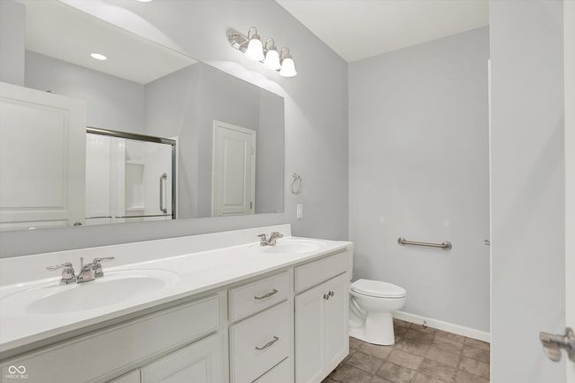 bathroom with double vanity and an enclosed shower | Image 12