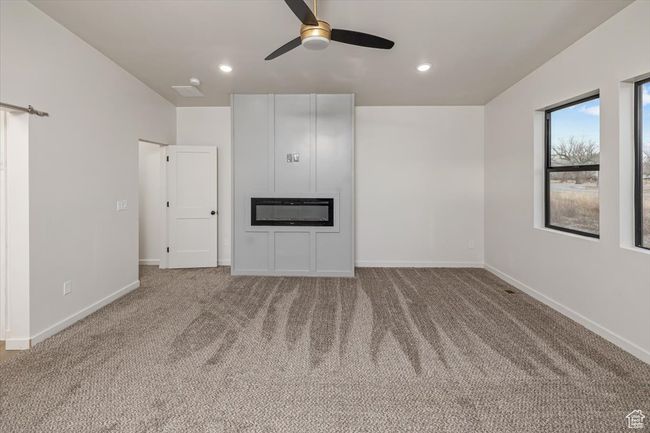 Unfurnished living room with carpet flooring and ceiling fan | Image 17