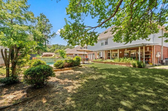 View of back of the home and yard. There is so much space to enjoy with your loved ones or for entertaining friends This neighborhood also offers easy access to Grapevine Lake and miles of hiking/biking trails! | Image 12