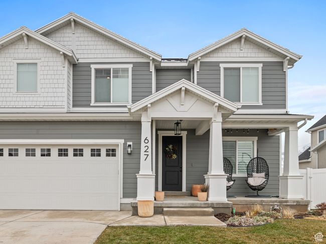 Craftsman-style home featuring covered porch, a garage, and driveway | Image 4