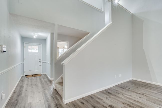 Foyer with a textured ceiling and light hardwood / wood-style floors | Image 6