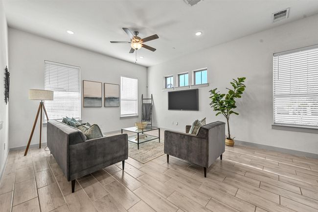 Living room featuring ceiling fan, a wealth of natural light, and light hardwood / wood-style flooring | Image 9