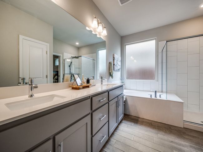 Spa-like primary bathroom with a large soaking tub and walk-in shower! | Image 20