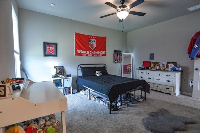 Carpeted bedroom featuring ceiling fan | Image 25