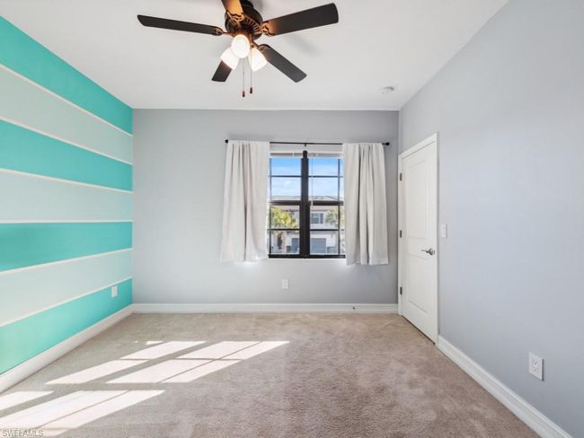 Unfurnished room featuring ceiling fan and light colored carpet | Image 10