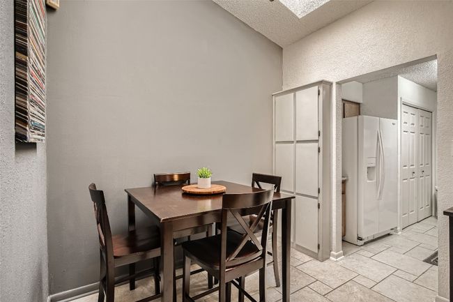 Dining space featuring a textured wall and a textured ceiling | Image 9