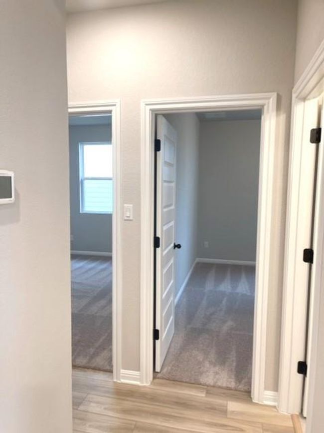 Hallway featuring wood finished floors and carpet | Image 6