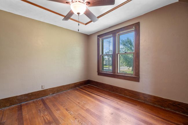 Spare room featuring hardwood / wood-style flooring, ceiling fan, and baseboards | Image 27