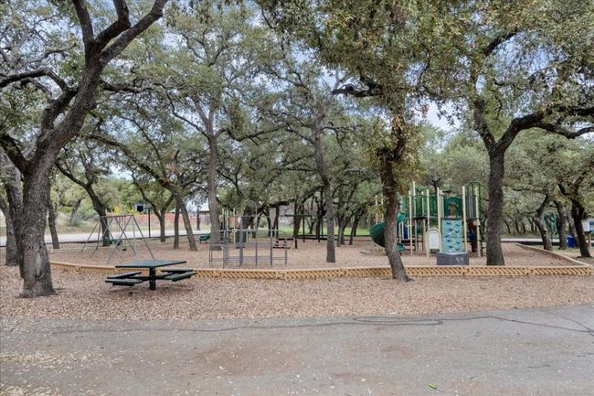 Another view of the playground with picnic tables. | Image 13