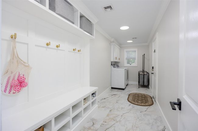 Mudroom with washer and clothes dryer, ornamental molding, recessed lighting, and light marble finish flooring | Image 14