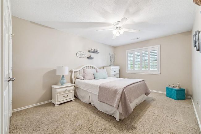 Generous sized bedroom featuring a large walk-in closet and convenient walk-in attic storage. | Image 25