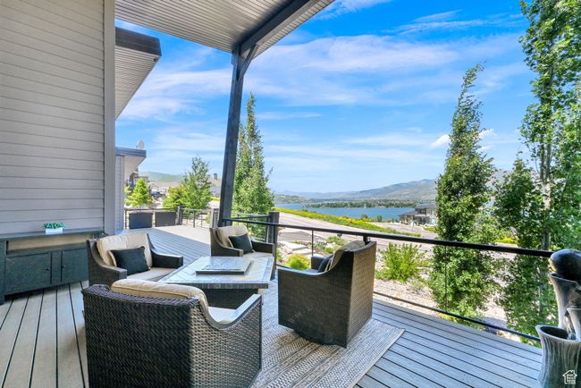Deck featuring a water and mountain view | Image 79