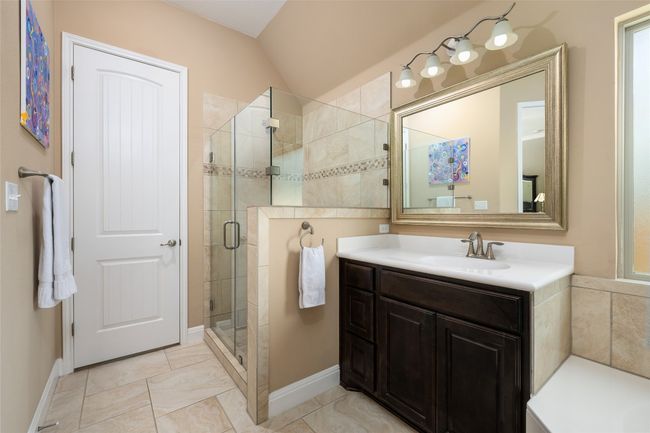 Full bath with a stall shower, vanity, and lofted ceiling | Image 22