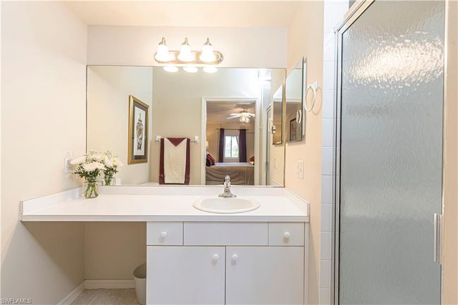 Bathroom with vanity and a shower with shower door | Image 16