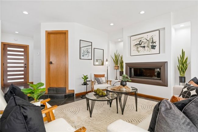 Entering the residence you are immediately embraced by the large and open floor plan with black slate tile. | Image 7