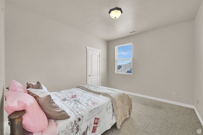 Carpeted bedroom with baseboards and visible vents | Image 37