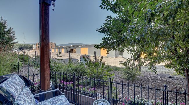 Back Patio offers privacy and comfort. Fenced in for a small dog, pull down shades for the late summer months. Beautiful sunsets. Secure storage closet located off patio. | Image 33
