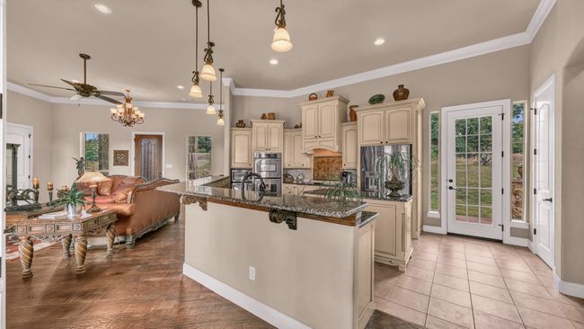 Kitchen with a center island with sink, dark stone counters, stainless steel appliances, recessed lighting, and cream cabinetry | Image 12