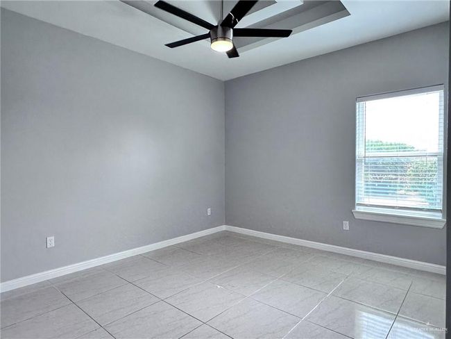 Spare room featuring baseboards, ceiling fan, and light tile patterned floors | Image 16