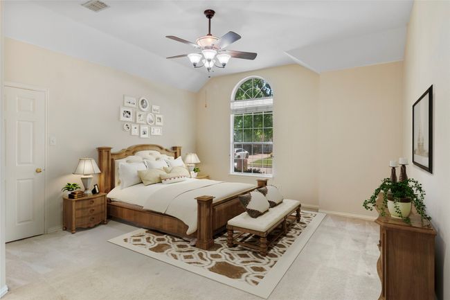 Bedroom with light carpet, baseboards, ceiling fan, and lofted ceiling | Image 11