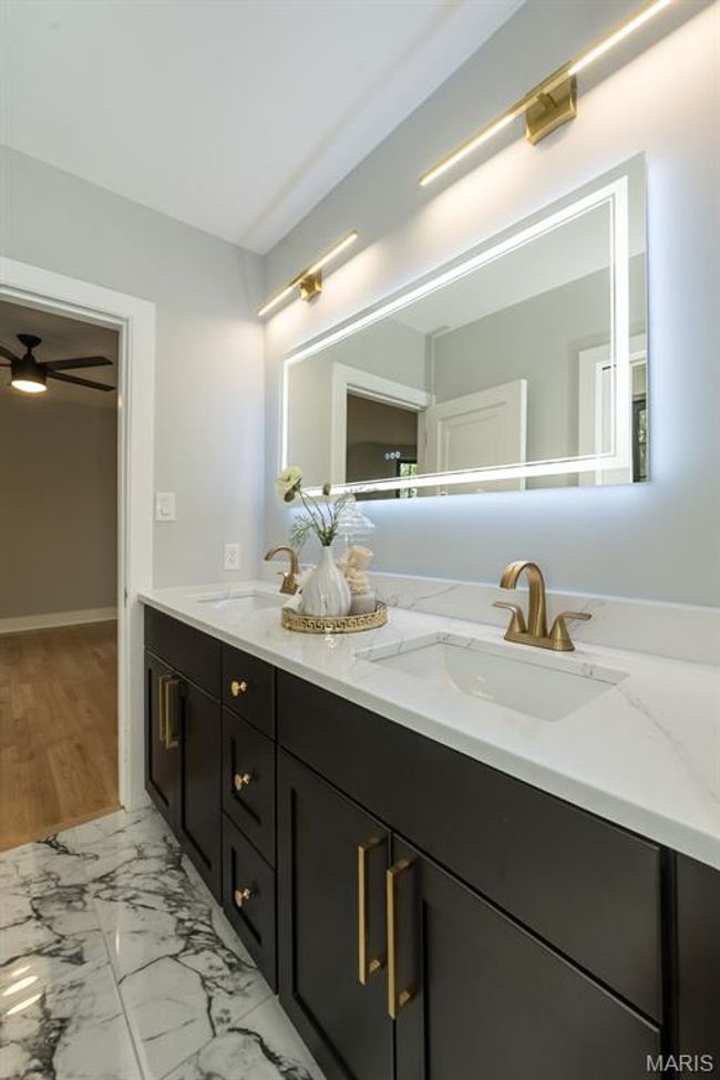 Jack n Jill bath connects the 2nd and 3rd bedroom. Lighted mirror, custom tile, Kohler fixtures and quartz counters! | Image 23