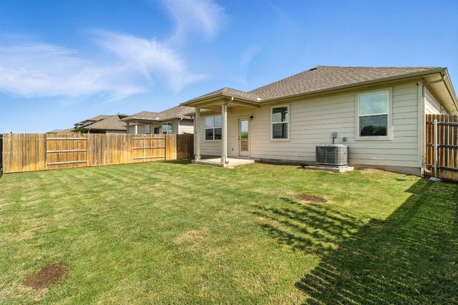 Back of house featuring a fenced backyard and a patio | Image 23