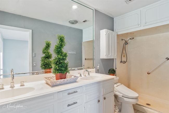 Bathroom featuring a sink, toilet, a stall shower, and double vanity | Image 17