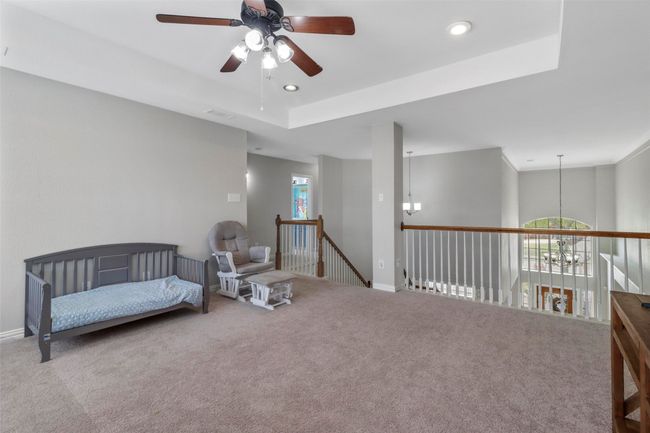 Sitting room featuring ceiling fan, carpet flooring, a chandelier, and recessed lighting | Image 23