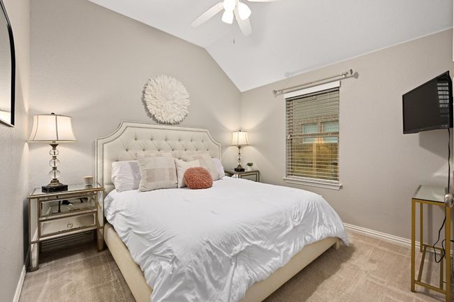 Carpeted bedroom featuring lofted ceiling and a ceiling fan | Image 19