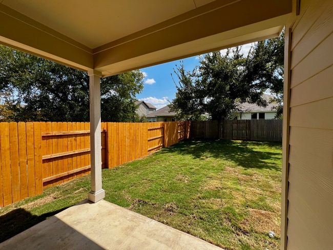 Fenced backyard with a patio | Image 19