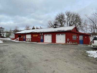 Across the driveway/parking area is the Kennel/Daycare building. | Image 3